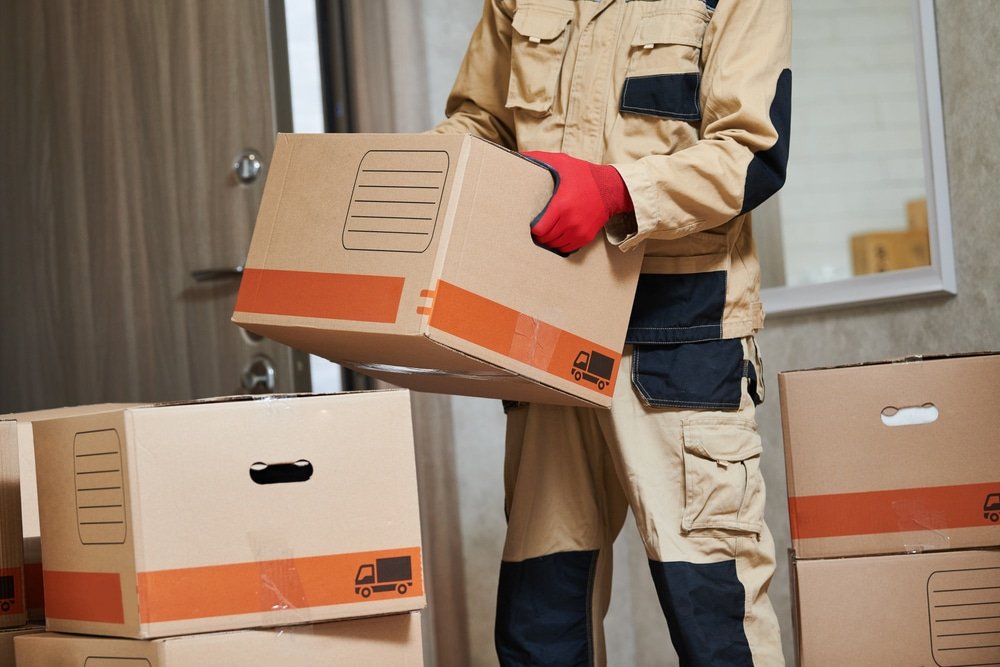 Moving,Or,Delivery,Service.,Mover,Worker,Carrying,Cardboard,Boxes,Into